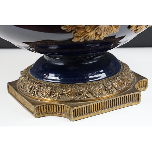 70 - Cobalt blue porcelain & bronze twin-handled centre bowl, with reeded bronze rim, raised on a quatref... 