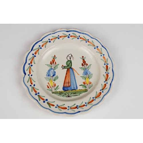 75 - Pair of late 19th / early 20th century Quimper dishes, with typical polychrome decoration of a man a... 