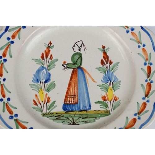 75 - Pair of late 19th / early 20th century Quimper dishes, with typical polychrome decoration of a man a... 