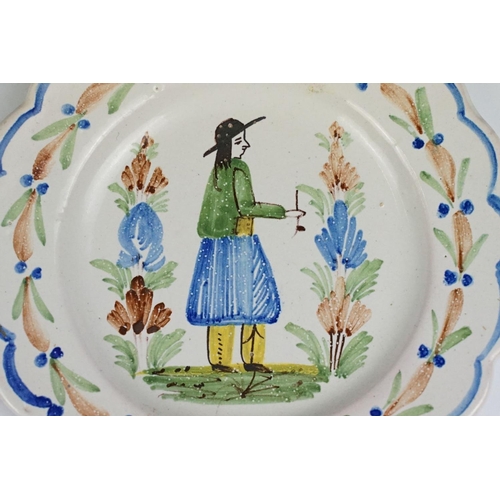 75 - Pair of late 19th / early 20th century Quimper dishes, with typical polychrome decoration of a man a... 