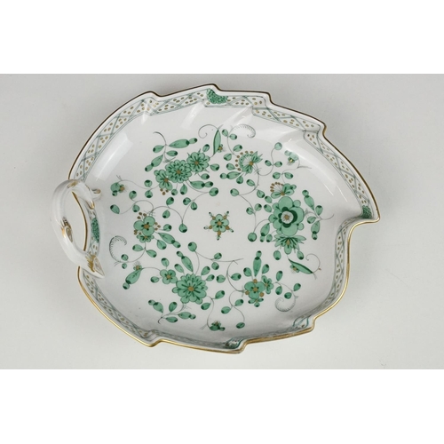 77 - Meissen porcelain leaf shaped dish, with hand painted green floral decoration, stem-form loop handle... 