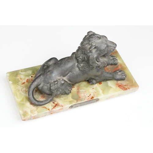 168 - 'Souvenir de Belfort' spelter figure of a recumbent lion, raised on a rectangular onyx base, 22cm wi... 