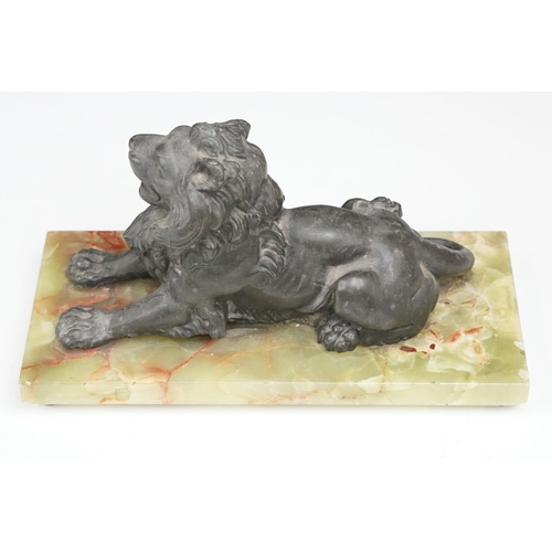 168 - 'Souvenir de Belfort' spelter figure of a recumbent lion, raised on a rectangular onyx base, 22cm wi... 