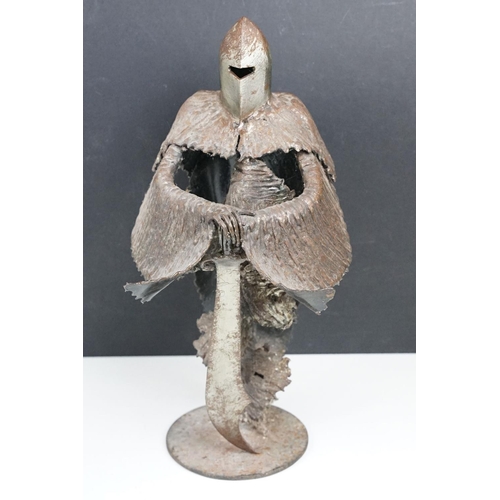 169 - Ron Lyon stylised metal sculpture of a Medieval knight, raised on a circular base, label to undersid... 