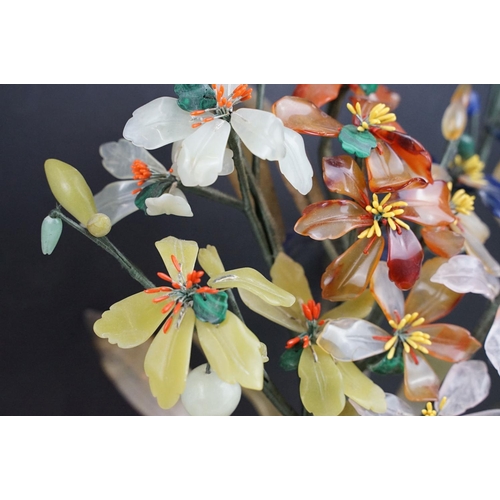 172 - Chinese Hardstone Flower held in a Cloisonne Bowl decorated with flowers on a blue ground, 43cm high