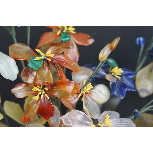 172 - Chinese Hardstone Flower held in a Cloisonne Bowl decorated with flowers on a blue ground, 43cm high