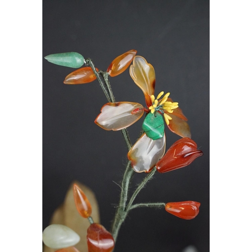 172 - Chinese Hardstone Flower held in a Cloisonne Bowl decorated with flowers on a blue ground, 43cm high