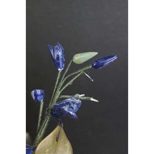 172 - Chinese Hardstone Flower held in a Cloisonne Bowl decorated with flowers on a blue ground, 43cm high