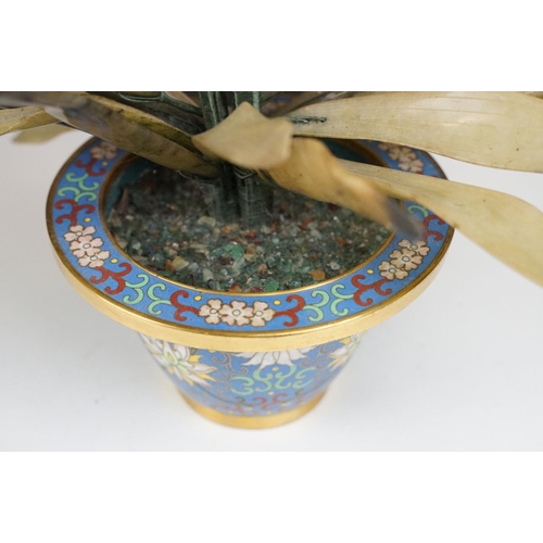 172 - Chinese Hardstone Flower held in a Cloisonne Bowl decorated with flowers on a blue ground, 43cm high