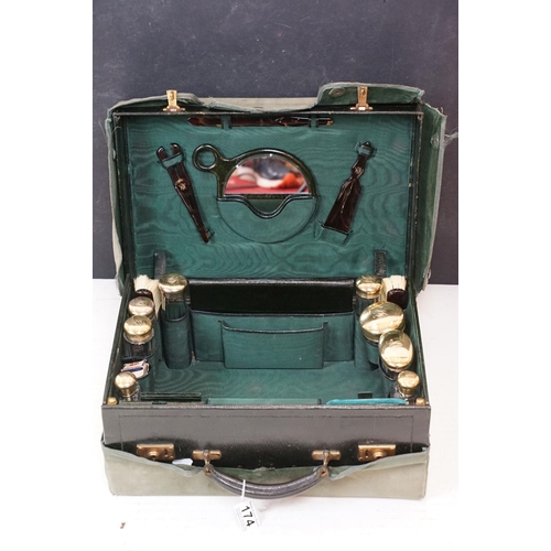 174 - Early 20th century travelling vanity case, the fitted interior with contents to include eight glass ... 