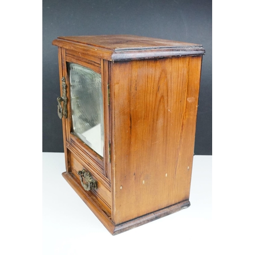 180 - Early 20th century pine smokers cabinet, the door with bevelled mirror to front, drawer below with c... 