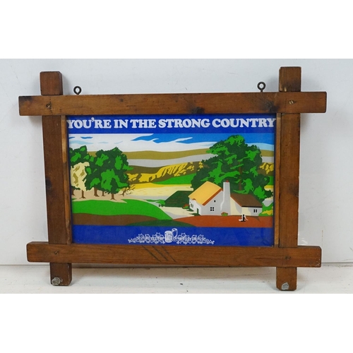 181 - ' You're In The Strong Country ' wooden framed hanging pub sign, approx 64cm W x 46.5cm H