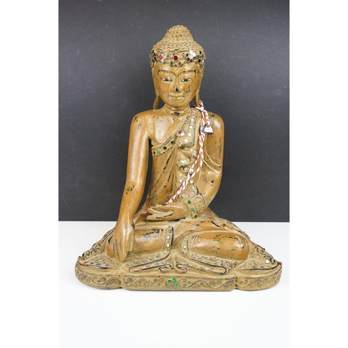 182 - Carved wooden figure of a Thai seated Buddha, with serene facial expression, sequinned & gilt detail... 