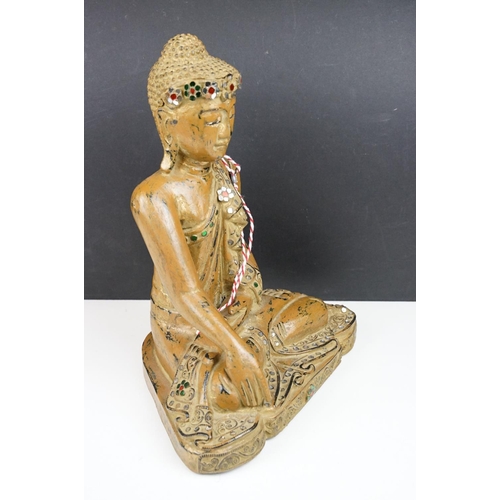 182 - Carved wooden figure of a Thai seated Buddha, with serene facial expression, sequinned & gilt detail... 