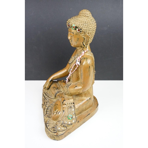 182 - Carved wooden figure of a Thai seated Buddha, with serene facial expression, sequinned & gilt detail... 