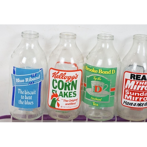 410 - Advertising - A collection of 32 glass milk bottles advertising a variety of brands to include Kello... 