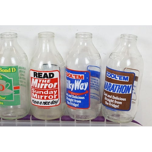 410 - Advertising - A collection of 32 glass milk bottles advertising a variety of brands to include Kello... 