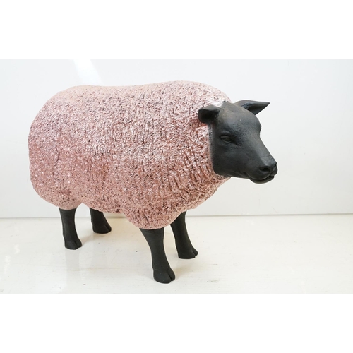 165 - Large painted fibreglass model of a sheep, in black & metallic pink. Measures approx 70cm H x 100cm ... 