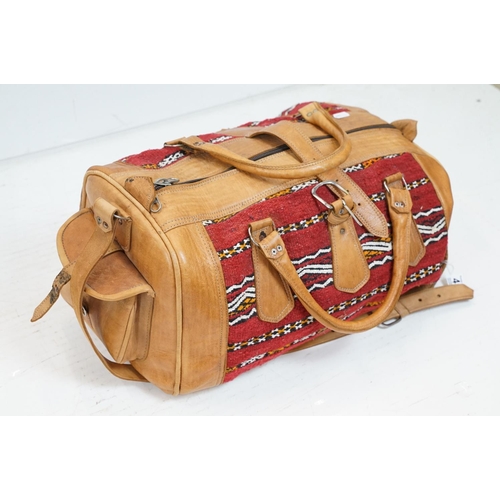 447 - Sri Lanka embossed leather holdall bag with floral & elephant decoration (approx 50cm wide, broken z... 