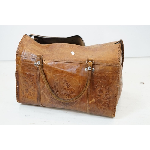 447 - Sri Lanka embossed leather holdall bag with floral & elephant decoration (approx 50cm wide, broken z... 