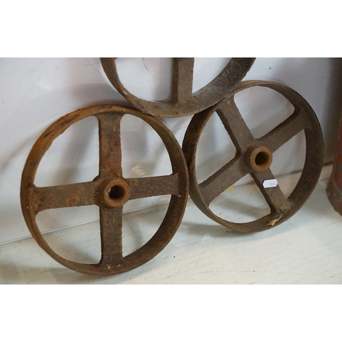 433 - Red painted metal fire bucket containing four cast iron spoked wheels (approx 23.5cm diameter), toge... 