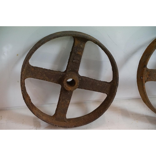 433 - Red painted metal fire bucket containing four cast iron spoked wheels (approx 23.5cm diameter), toge... 