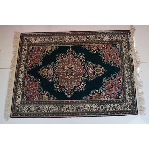 694 - Dark Blue and Pink Ground Rug decorated with flowers and geometric patterns within a cream ground bo... 