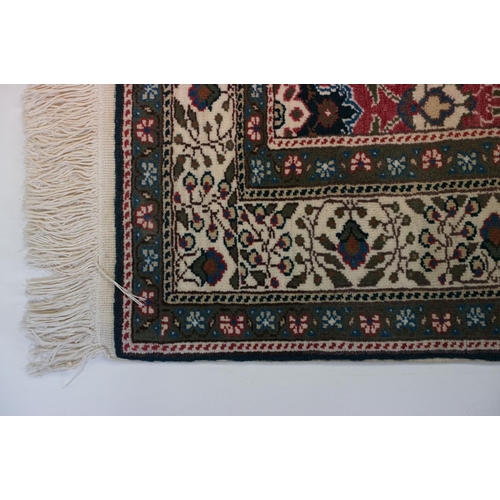 694 - Dark Blue and Pink Ground Rug decorated with flowers and geometric patterns within a cream ground bo... 