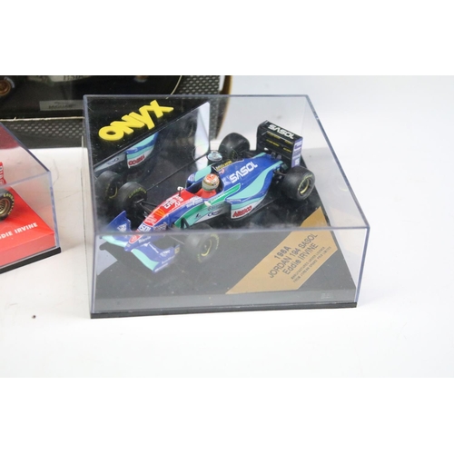 121 - Nine boxed / cased diecast racing car models to include examples from Onyx, Hot Wheels and Minichamp... 