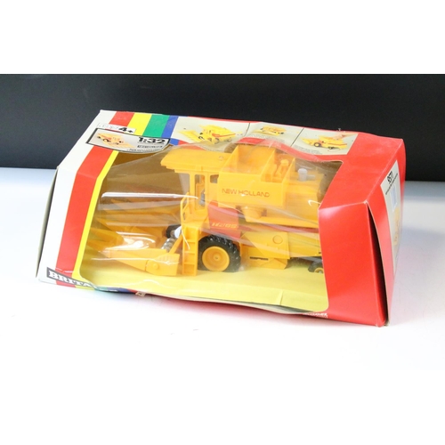 154 - Two boxed farming tractor diecast models to include Britains 9571 New Holland TR85 Combine Harvester... 