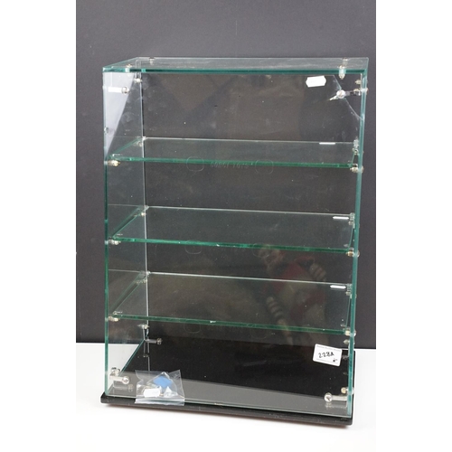 228A - Mid 20th C Corgi Toys glass shop counter display case, with three glass shelves, raised on a black g... 