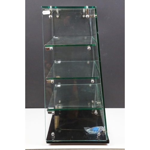 228A - Mid 20th C Corgi Toys glass shop counter display case, with three glass shelves, raised on a black g... 