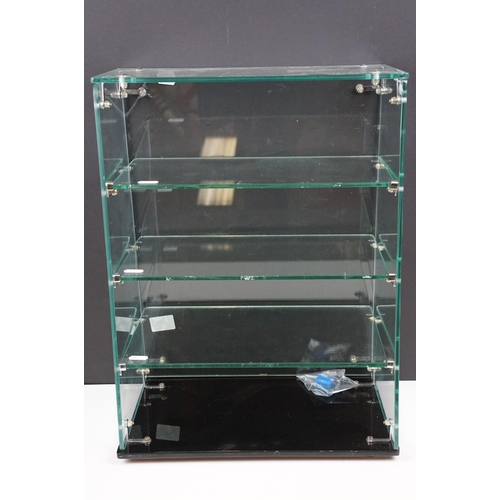 228A - Mid 20th C Corgi Toys glass shop counter display case, with three glass shelves, raised on a black g... 