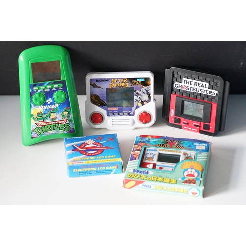 383 - Retro Gaming - Five circa 1990s handheld video games to include Grandstand Sega After Burner, Konami... 