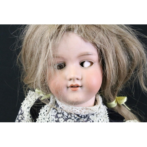 280 - Five early 20th C Armand Marseille bisque headed dolls, clothed, with sleeping glass eyes, jointed c... 