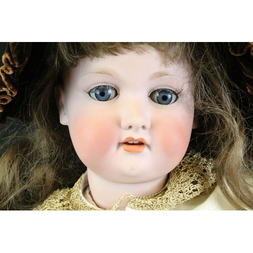 295 - Large early 20th C Armand Marseille bisque headed doll, clothed, with sleeping eyes, rosy cheeky, op... 