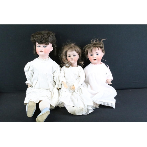 296A - Three early 20th century Heubach Koppelsdorf bisque headed dolls, clothed, with composition limbs, s... 