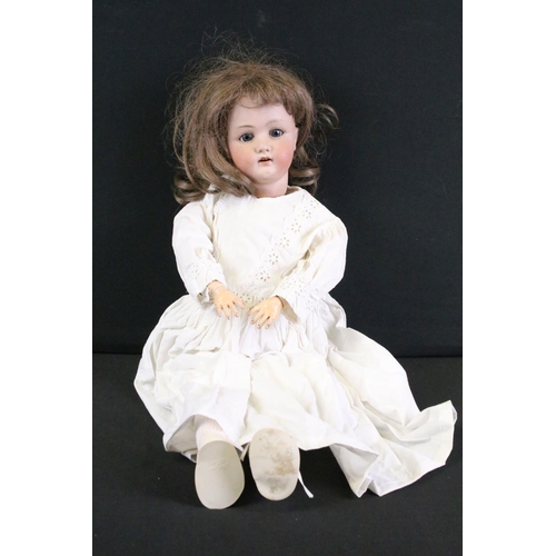 296A - Three early 20th century Heubach Koppelsdorf bisque headed dolls, clothed, with composition limbs, s... 