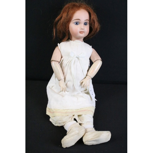 297A - Three early 20th century bisque headed dolls with glass eyes, composition jointed limbs and painted ... 