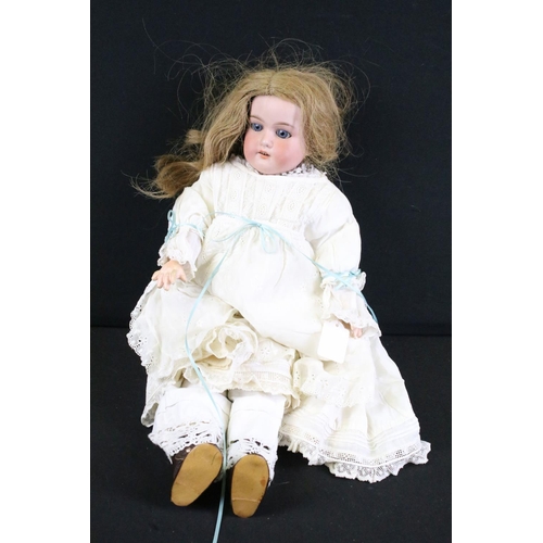 297A - Three early 20th century bisque headed dolls with glass eyes, composition jointed limbs and painted ... 