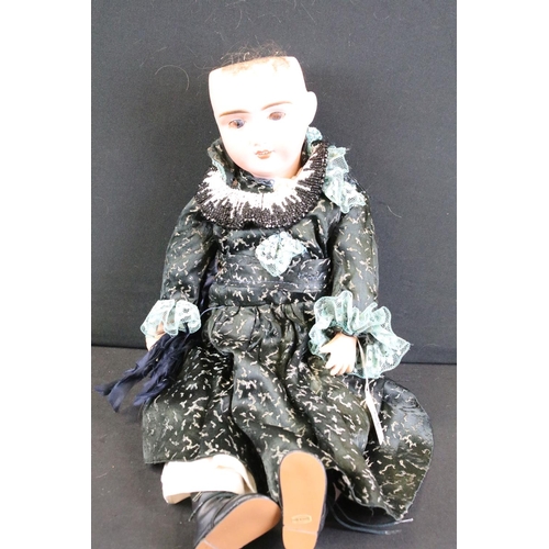 297A - Three early 20th century bisque headed dolls with glass eyes, composition jointed limbs and painted ... 