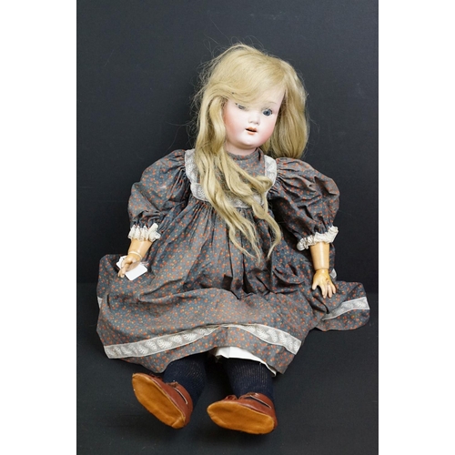 299A - Three early 20th century Heubach Koppelsdorf bisque headed dolls, clothed, with composition limbs, g... 