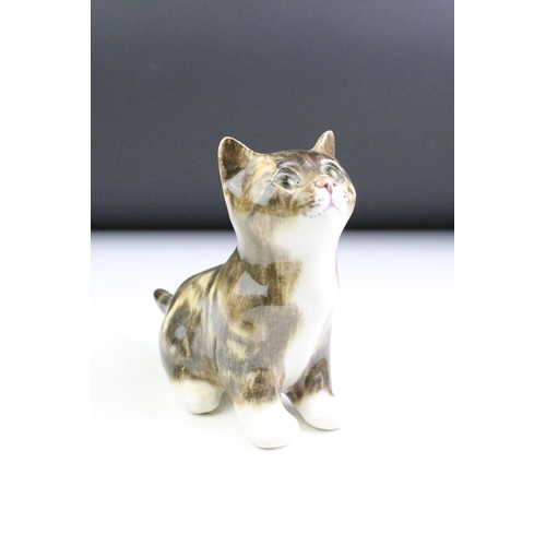 10 - Three Winstanley Pottery cat figures with glass eyes, to include a recumbent tabby cat (size 2), a t... 