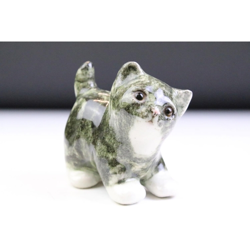 10 - Three Winstanley Pottery cat figures with glass eyes, to include a recumbent tabby cat (size 2), a t... 