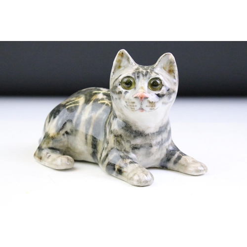 10 - Three Winstanley Pottery cat figures with glass eyes, to include a recumbent tabby cat (size 2), a t... 