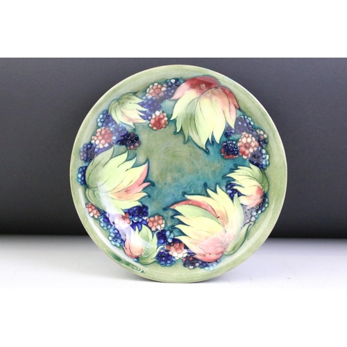 23 - William Moorcroft 'Leaf and Berry' pattern green ground circular dish, signed to reverse, impressed ... 