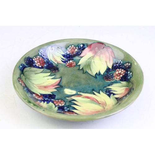 23 - William Moorcroft 'Leaf and Berry' pattern green ground circular dish, signed to reverse, impressed ... 