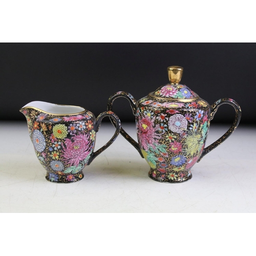 46 - 20th Century Chinese Famille Jaune tea set, with Chrysanthemum floral decoration on a black & gilt s... 