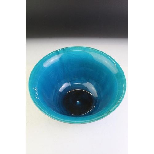 82 - Chinese blue glazed flared rim bowl raised on footed base. Unmarked. Measures 27.5cm diameter.