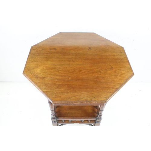 592 - Early 20th century Walnut Octagonal Table raised on turned legs united by an undershelf and raised o... 